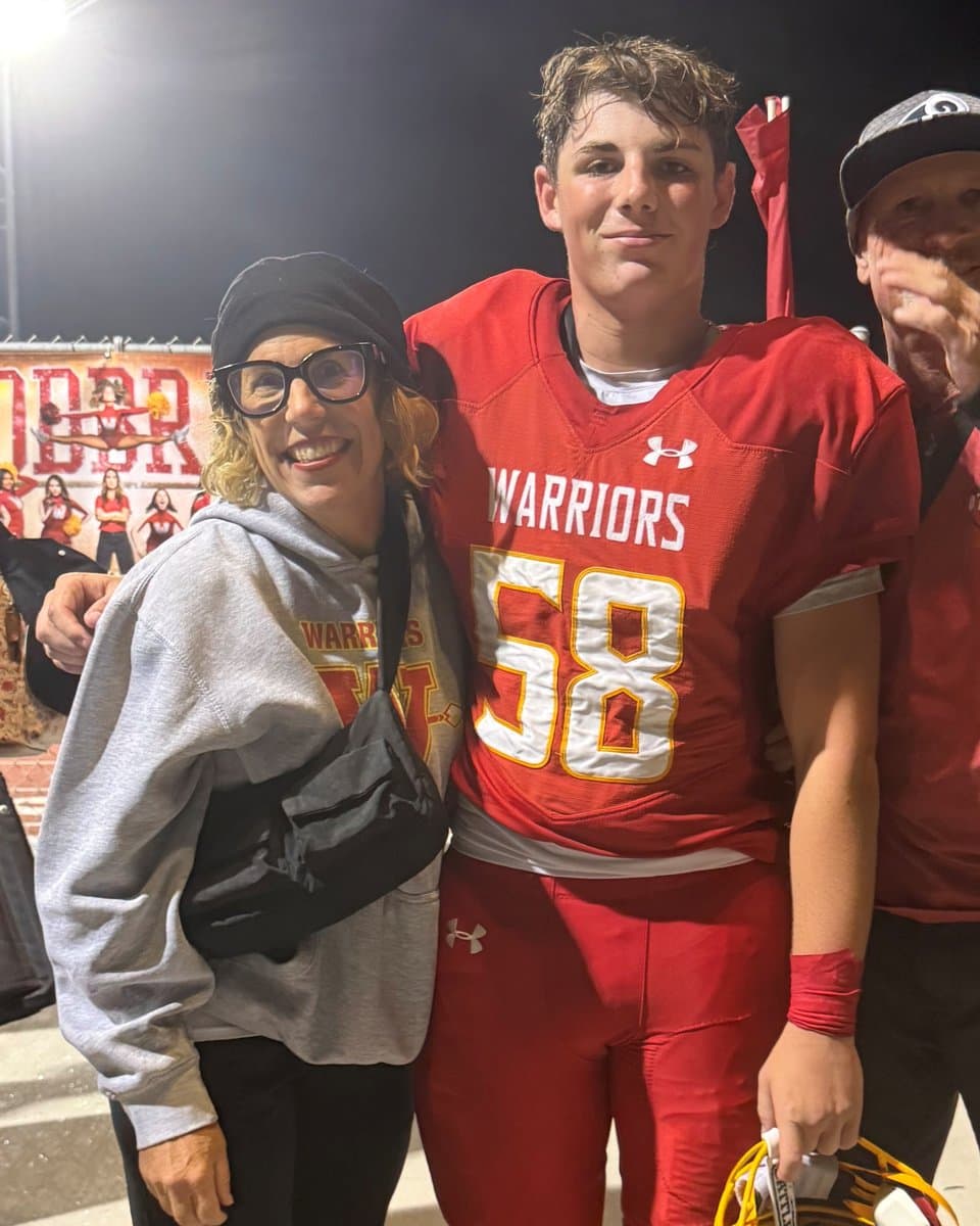 Nikki Yeager with her son at a night football game